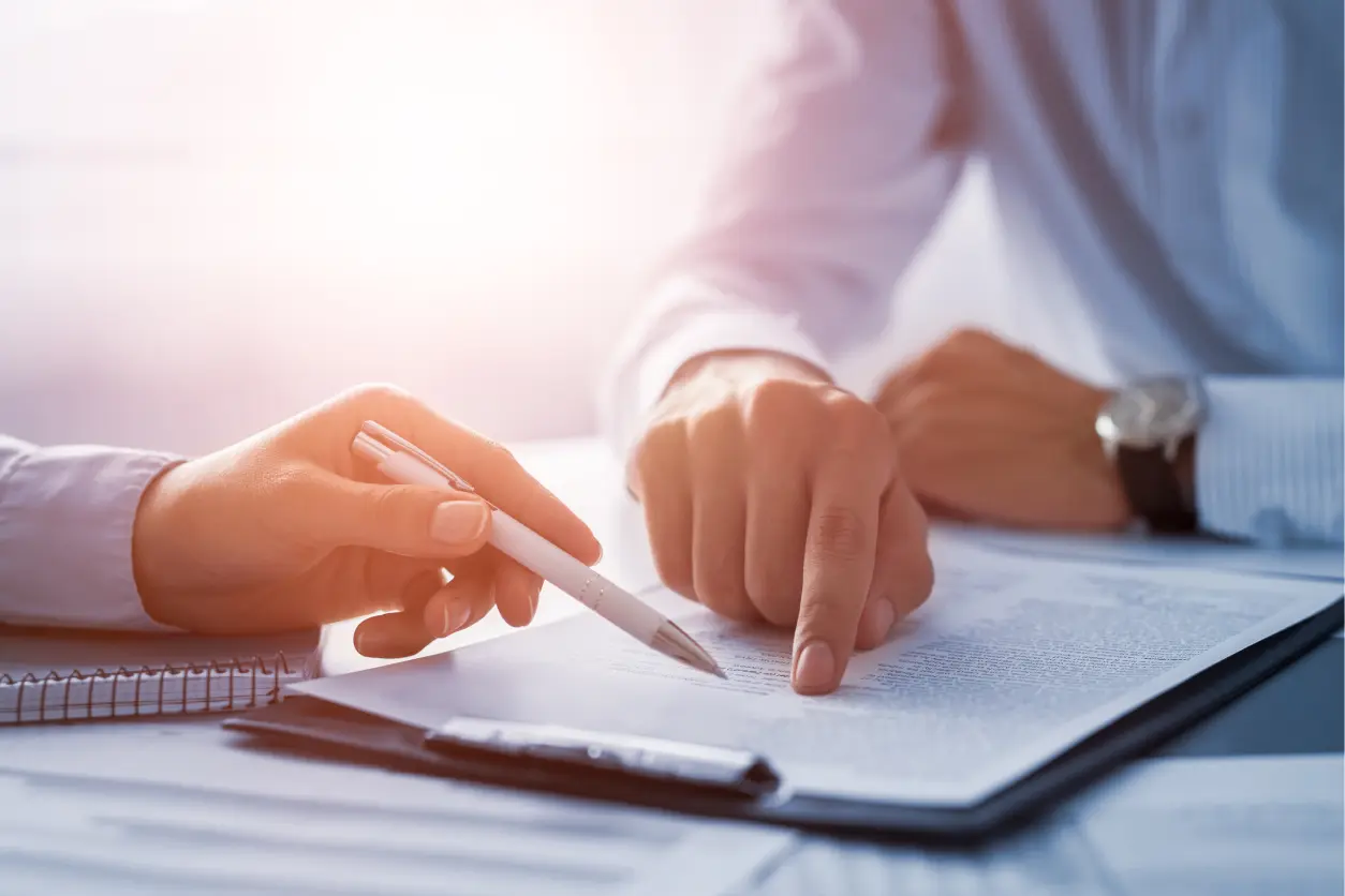 Two people reviewing a document together.