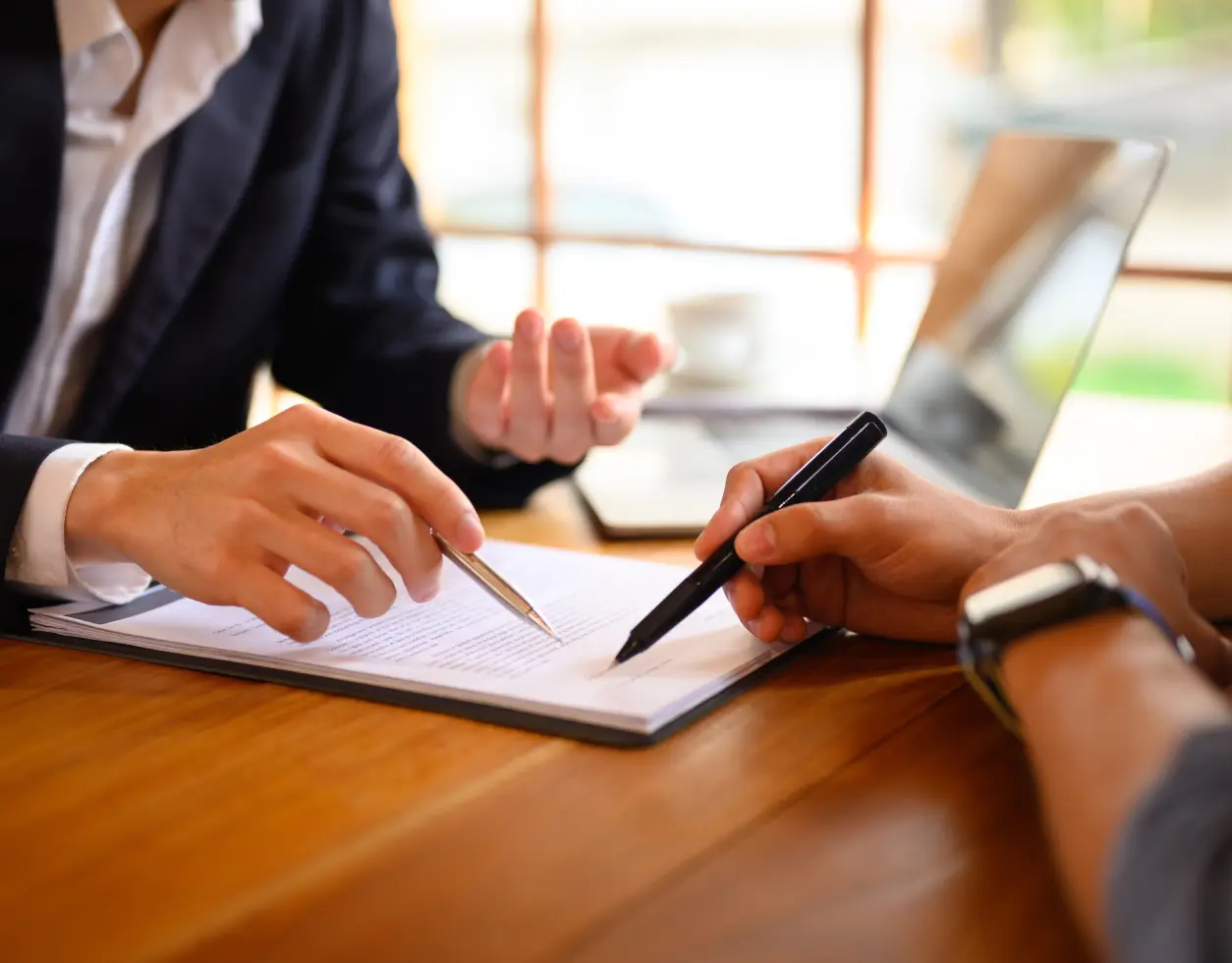 People discussing documents at a table.