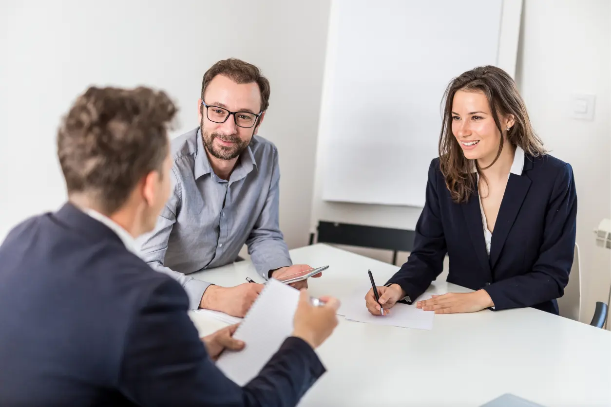 Three people having a business meeting.